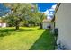Expansive backyard with lush green lawn and mature trees, perfect for outdoor activities at 10148 Eventide Ct, Orlando, FL 32821
