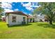 Well-maintained backyard featuring a lush lawn and tiled roofline at 10148 Eventide Ct, Orlando, FL 32821
