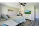 Cozy bedroom with a neutral color palette, ceiling fan and a view to the bathroom at 10148 Eventide Ct, Orlando, FL 32821