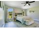 Bright bedroom featuring a ceiling fan, two large windows, and neutral colored walls at 10148 Eventide Ct, Orlando, FL 32821