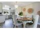 Elegant dining area featuring a chic chandelier, neutral decor, and adjacent kitchen space at 10148 Eventide Ct, Orlando, FL 32821