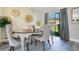 Inviting dining room with a modern chandelier, seating for four, and sliding glass doors to the backyard at 10148 Eventide Ct, Orlando, FL 32821