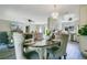 Open-concept dining area with stylish chandelier, seating for four, and seamless flow to the kitchen at 10148 Eventide Ct, Orlando, FL 32821
