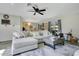 Spacious living room with a comfortable sectional, ceiling fan, and view into the dining area at 10148 Eventide Ct, Orlando, FL 32821
