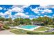 A sunny community pool area featuring a spa, shaded seating, and well-maintained landscaping at 10148 Eventide Ct, Orlando, FL 32821