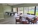 Bright recreation room with pool table, large windows, tables, chairs, and slider at 10148 Eventide Ct, Orlando, FL 32821