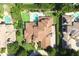 High-angle aerial view of a home with a pool, manicured landscaping, and an inviting outdoor entertainment area at 11013 Ullswater Ln, Windermere, FL 34786