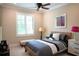 Inviting bedroom with a modern bedframe, window with plantation shutters, and a coordinating bench at 11013 Ullswater Ln, Windermere, FL 34786