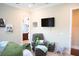Bedroom features a comfortable chair and ottoman, wall-mounted TV, and access to the bathroom at 11013 Ullswater Ln, Windermere, FL 34786