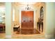 Grand foyer featuring marble floors, an elegant chandelier, and a beautifully crafted wooden double door entry at 11013 Ullswater Ln, Windermere, FL 34786