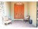Welcoming front porch with seating, showcasing an arched doorway and ornate wooden double doors for an inviting arrival at 11013 Ullswater Ln, Windermere, FL 34786