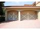Detached garage with white carriage-style doors, brick paving and ample parking space at 11013 Ullswater Ln, Windermere, FL 34786