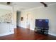 Elegant hallway with hardwood floors, decorative wrought iron, and an entertainment center with a large-screen TV at 11013 Ullswater Ln, Windermere, FL 34786