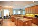 Open kitchen with stainless steel appliances, granite countertops, and an island with a sink at 11013 Ullswater Ln, Windermere, FL 34786