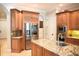 Spacious kitchen with granite countertops, stainless steel appliances, and custom wood cabinetry at 11013 Ullswater Ln, Windermere, FL 34786