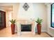Living room showcasing an ornate fireplace with decorative accents and tall plant vases flanking each side at 11013 Ullswater Ln, Windermere, FL 34786