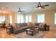 Bright living room with a large sectional sofa, decorative pillows, and a view into the dining area at 11013 Ullswater Ln, Windermere, FL 34786
