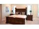 Main bedroom features a large wood headboard and matching nightstands at 11013 Ullswater Ln, Windermere, FL 34786