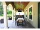 Luxurious outdoor living area features a built-in bar, dining space, and comfortable seating area at 11013 Ullswater Ln, Windermere, FL 34786