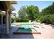 An in-ground pool with hot tub is surrounded by green grass and mature landscaping at 11013 Ullswater Ln, Windermere, FL 34786