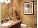 Well-appointed powder room with a marble countertop, decorative mirror, and stylish accents for a luxurious feel at 11013 Ullswater Ln, Windermere, FL 34786
