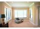 Cozy sitting room filled with natural light offers comfortable seating and views from many windows at 11013 Ullswater Ln, Windermere, FL 34786