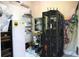 The utility room shows a refrigerator, wall-mounted monitors, and a rack of computer and networking equipment at 11013 Ullswater Ln, Windermere, FL 34786