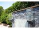A close-up of the modern water feature shows stone accents and built-in planters at 11013 Ullswater Ln, Windermere, FL 34786