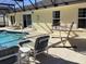 Inviting in-ground pool within a screened lanai, complete with lounge chairs and privacy at 116 Blackwater Ct, Kissimmee, FL 34743