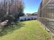 Large backyard with green lawn leading up to a private, wooded area and fenced perimeter at 116 Blackwater Ct, Kissimmee, FL 34743