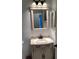 Bathroom vanity with a decorative mirror and backsplash at 116 Blackwater Ct, Kissimmee, FL 34743