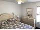 Bedroom featuring a large bed, dresser with mirror and a window at 116 Blackwater Ct, Kissimmee, FL 34743