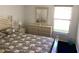 Bedroom featuring a large bed, dresser with mirror and a window at 116 Blackwater Ct, Kissimmee, FL 34743