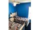 Blue bedroom with two twin beds and window at 116 Blackwater Ct, Kissimmee, FL 34743