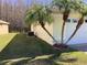 Exterior view of a home featuring well-manicured lawn and palm trees at 116 Blackwater Ct, Kissimmee, FL 34743