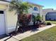 Exterior of the house with landscaped front yard with mulch and palm trees at 116 Blackwater Ct, Kissimmee, FL 34743