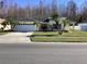 Exterior showcasing the home's beautiful landscaping, palm trees, and well-kept front lawn at 116 Blackwater Ct, Kissimmee, FL 34743