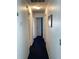 Bright hallway with dark blue carpet and multiple doors leading to various rooms in the house at 116 Blackwater Ct, Kissimmee, FL 34743