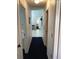 Hallway with tiled flooring and access to carpeted rooms at 116 Blackwater Ct, Kissimmee, FL 34743