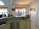 Open kitchen and dining area with granite countertops and stainless steel dishwasher at 116 Blackwater Ct, Kissimmee, FL 34743