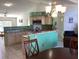 Open kitchen with granite counters, an eat-in bar and a seamless transition into the living area at 116 Blackwater Ct, Kissimmee, FL 34743