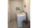 The laundry room has tile flooring, a utility sink, and a full-size washer and dryer at 116 Blackwater Ct, Kissimmee, FL 34743
