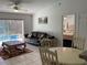 Cozy living room with a view of the screened-in pool area, providing an ideal indoor/outdoor flow at 116 Blackwater Ct, Kissimmee, FL 34743