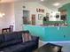The living room opens to kitchen with bar seating, stainless appliances, and modern features at 116 Blackwater Ct, Kissimmee, FL 34743