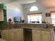 Open concept kitchen features granite counters, stainless appliances, and access to the living room at 116 Blackwater Ct, Kissimmee, FL 34743
