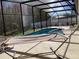 Sparkling screened-in pool area with a comfortable hammock for relaxation at 116 Blackwater Ct, Kissimmee, FL 34743