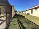 Side yard showcasing green grass and side view of neighboring houses at 116 Blackwater Ct, Kissimmee, FL 34743