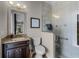 Bathroom features a granite vanity, tile surround shower, and modern fixtures for a fresh and updated look at 11755 Waterstone Loop Dr, Windermere, FL 34786