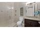 Bathroom with tiled shower, granite countertop, and dark cabinets plus decorative elements at 11755 Waterstone Loop Dr, Windermere, FL 34786