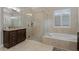 Bathroom featuring a glass enclosed shower, free standing soaking tub, and granite countertop vanity at 11755 Waterstone Loop Dr, Windermere, FL 34786